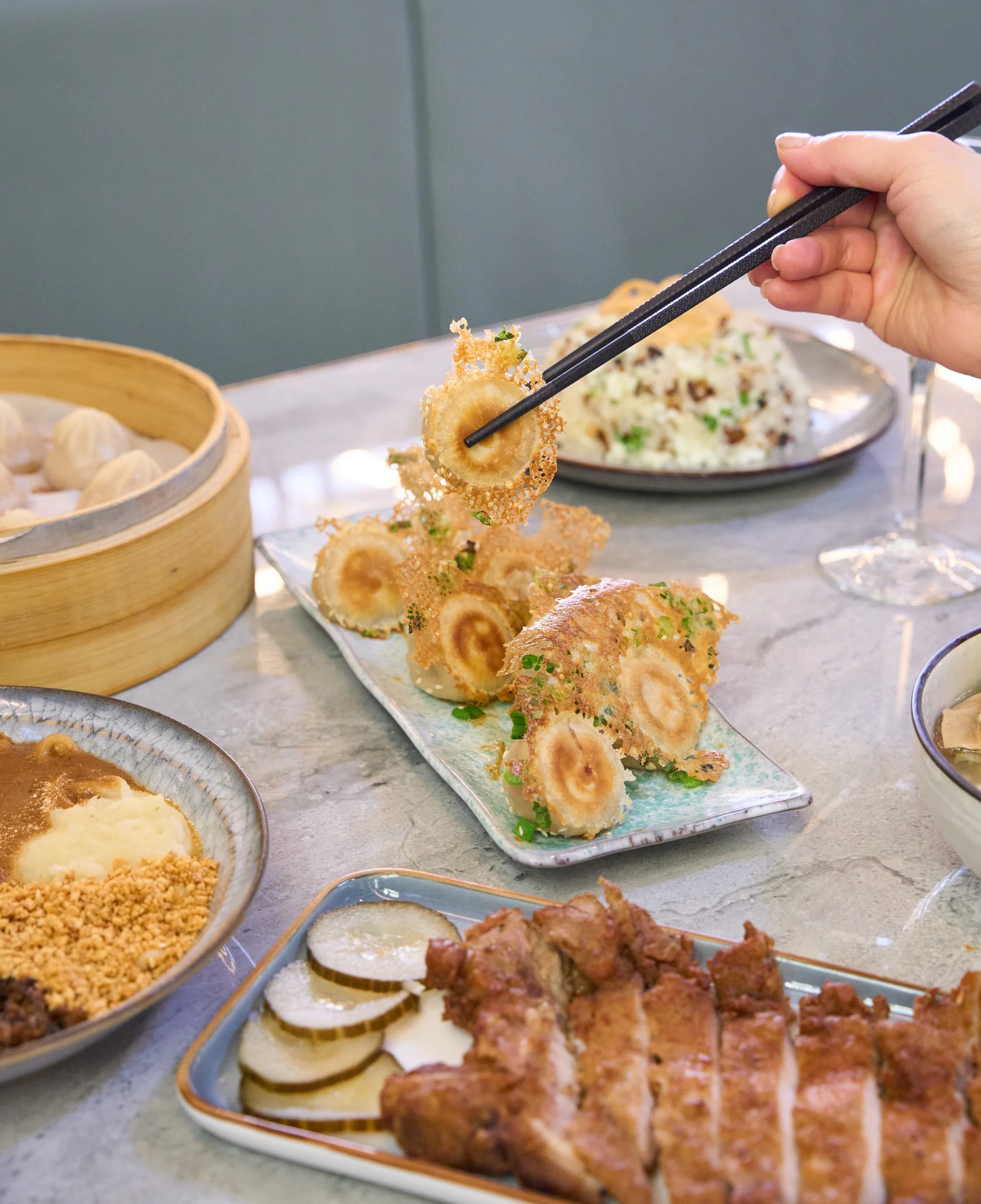 Friends sharing Xiao Long Bao and pan-fried dumplings at Supreme Dumplings